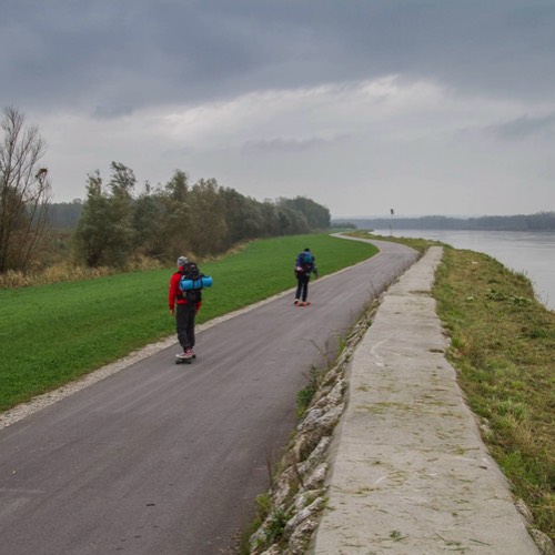 three friends longboarding the Danube cycling path