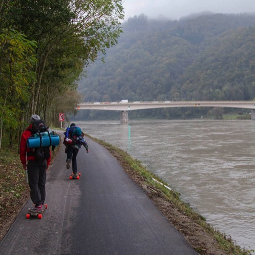 three friends longboarding the Danube cycling path